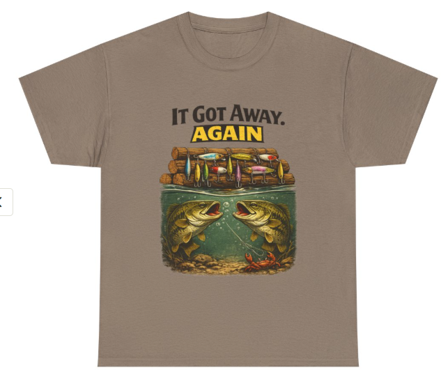 It Got Away Again’ fishing graphic t‑shirt in sand color on flat lay mockup