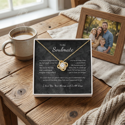 Love Knot necklace gift box on table with coffee and framed photo