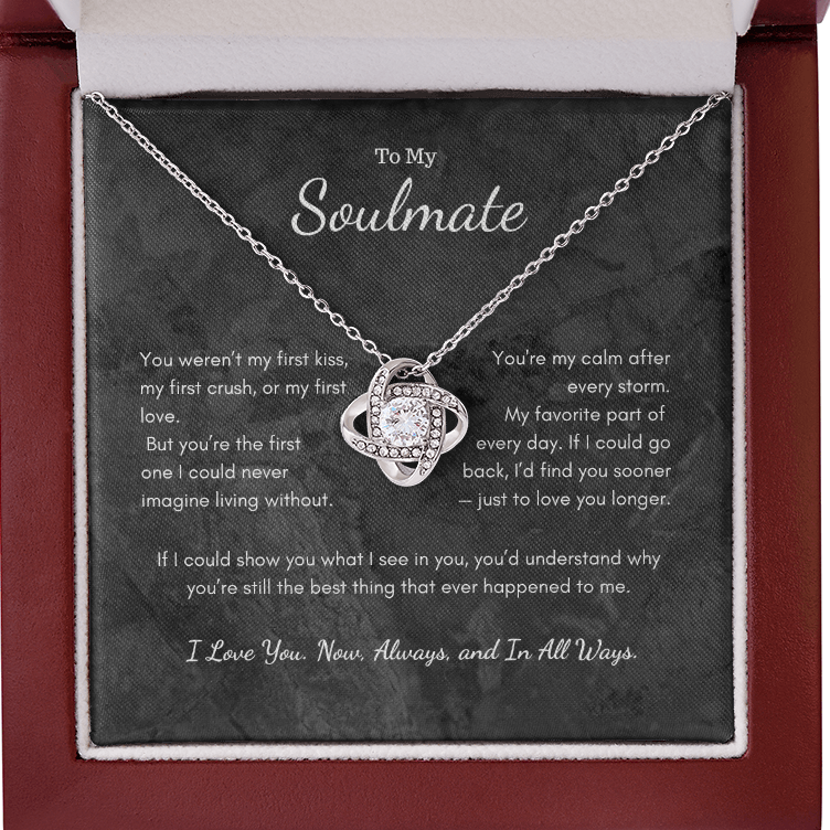 Silver Love Knot necklace displayed in open red gift box
