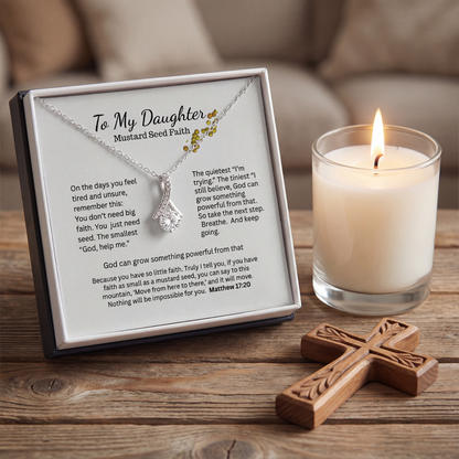 Necklace gift box with Mustard Seed Faith message card beside a candle and cross decor
