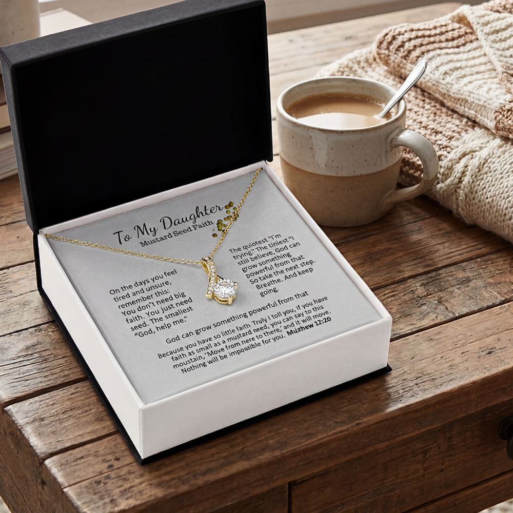 Mustard Seed Faith necklace gift box on a table beside a mug in a cozy home setting