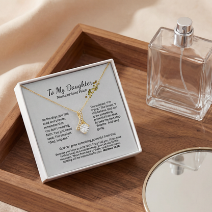 Mustard Seed Faith necklace gift box on a wood table with perfume for an elegant lifestyle flatlay