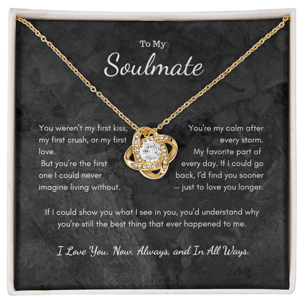 Love Knot necklace displayed in luxury gift box with romantic candle background