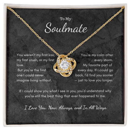 Love Knot necklace displayed in luxury gift box with romantic candle background